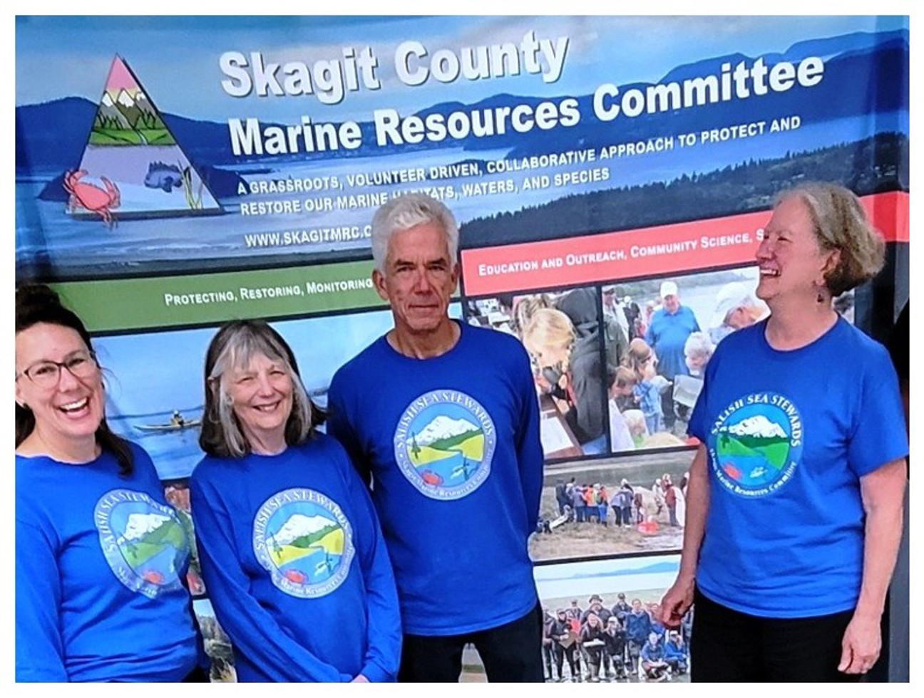Salish Sea Stewards volunteers in front of Skagit MRC outreach display